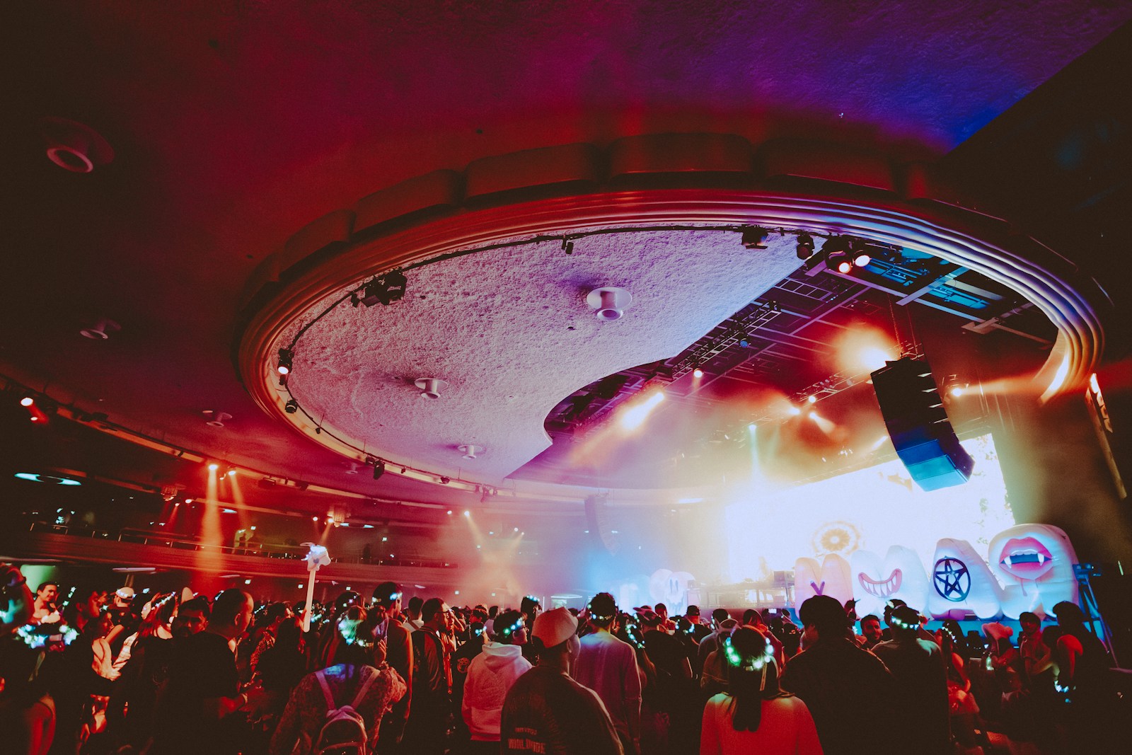 Colorful lights over a festival crowd