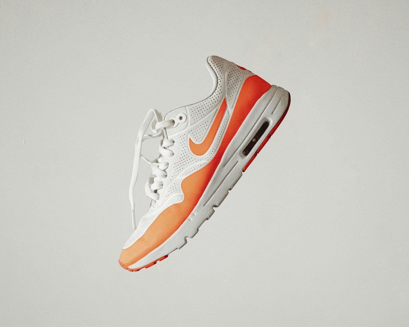 White and orange running shoe in the Strider store concept